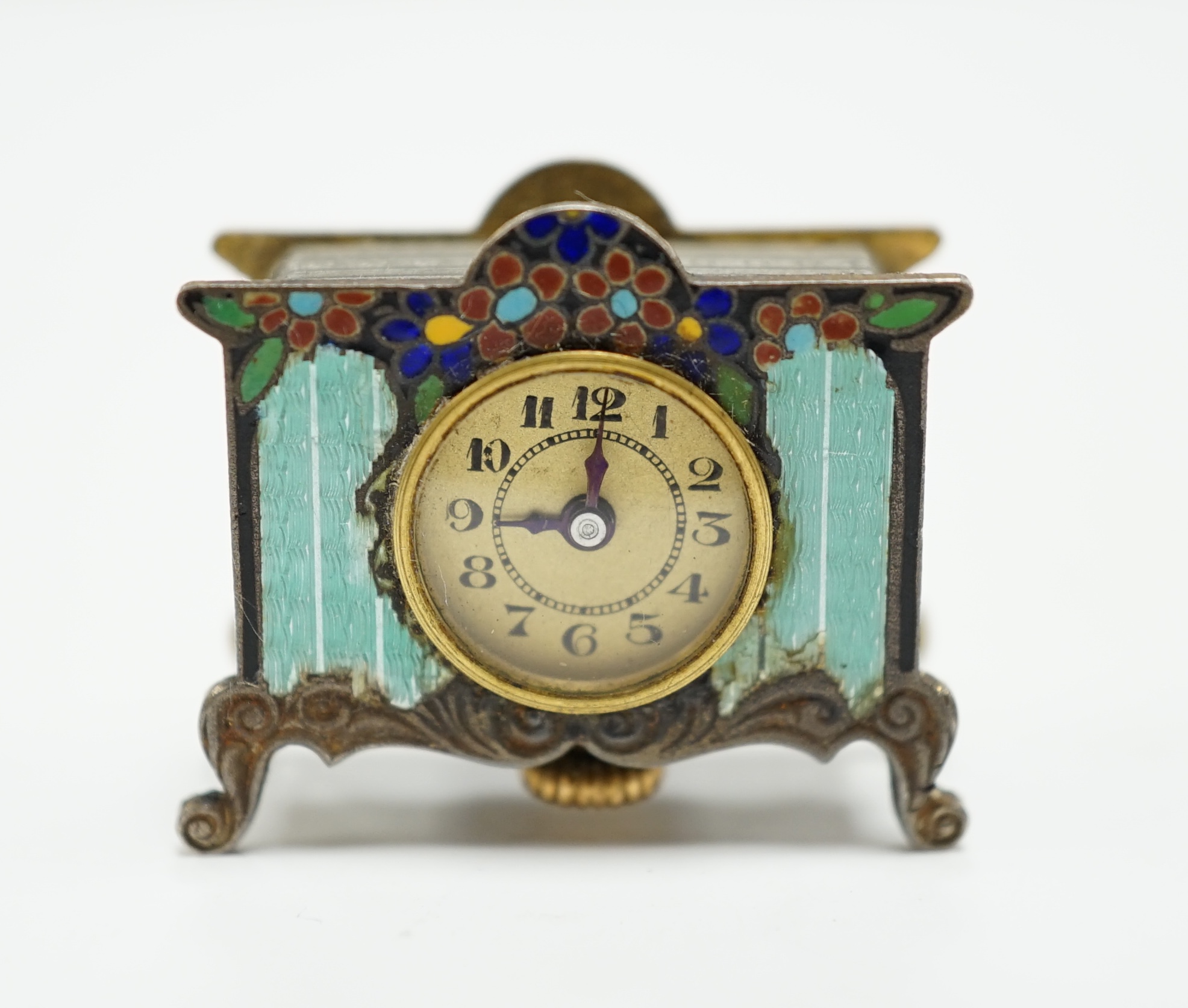 A miniature enamel timepiece modelled as a mantle clock, with watch movement, 2cm high, in fitted case